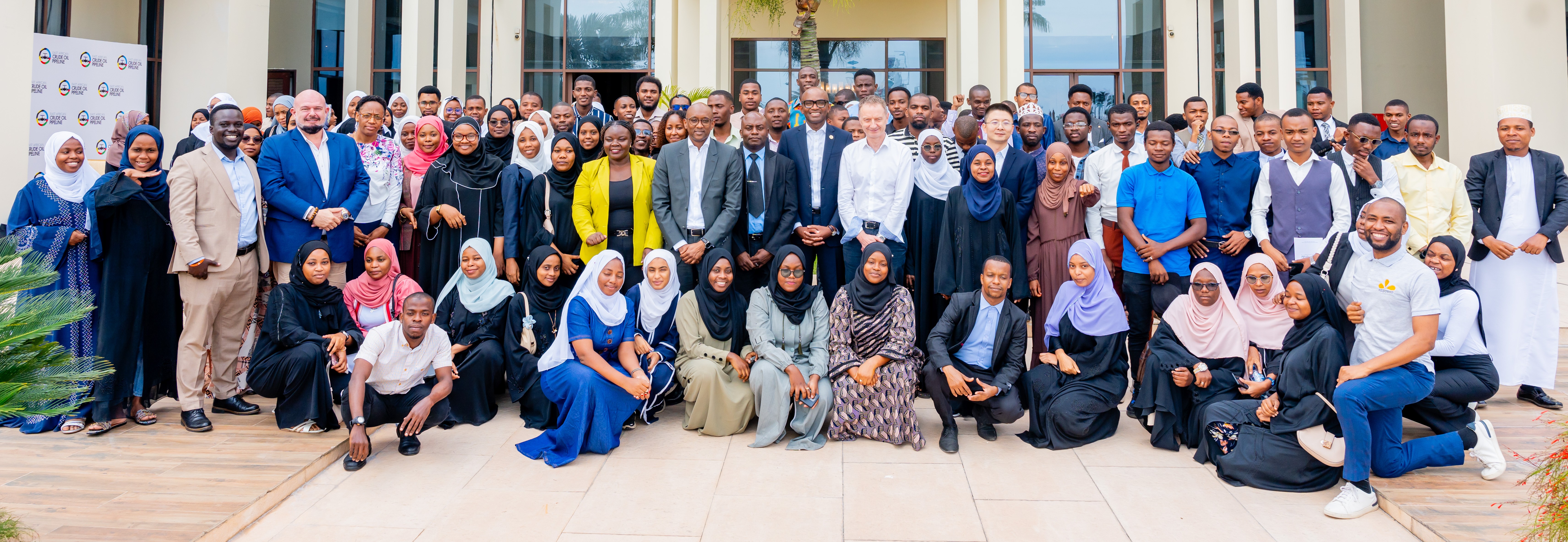 Zanzibar University students gathered along a tree-lined campus path